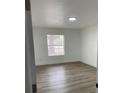 Bright bedroom with new wood-look flooring and a large window at 5921 Se 4Th Pl, Ocala, FL 34472