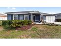 House exterior showcasing gray siding and landscaping at 6695 Sw 64Th Ter, Ocala, FL 34476