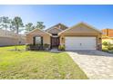 Front view of a house with a paver driveway at 6836 Sw 179Th Court Rd, Dunnellon, FL 34432