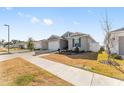 Single-story home with gray siding, white garage door, and landscaping at 7094 Sw 60Th Ln, Ocala, FL 34474