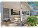 Front porch with white columns and railing, offering a peaceful view at 8681 Sw 93Rd Pl # B, Ocala, FL 34481