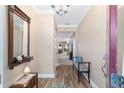 Inviting entryway with wood floors, decorative mirror, stylish bench, and elegant lighting at 1065 Ne 31St Ter, Ocala, FL 34470