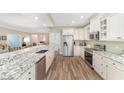 Open kitchen with stainless steel appliances, granite countertops, and wood flooring at 1065 Ne 31St Ter, Ocala, FL 34470