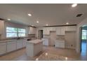 Modern kitchen with an island and white cabinets at 13392 Sw 33Rd Ct, Ocala, FL 34473