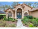 Front view of charming house with teal door and walkway at 19586 Sw 84Th Pl, Dunnellon, FL 34432