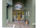 Inviting front porch with rocking chairs and decorative accents at 2831 Sw 139Th St, Ocala, FL 34473