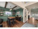 Wood-floored dining area with a rustic table and built-in bar at 4074 Sw 47Th Ct, Ocala, FL 34474