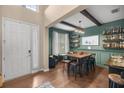 Bright entryway with white door, wood floors, and adjacent dining area at 4074 Sw 47Th Ct, Ocala, FL 34474