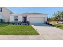 Single story house with a two-car garage and well-manicured lawn at 4388 Sw 56Th Pl, Ocala, FL 34474