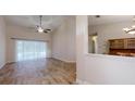 Bright living room with hardwood floors and sliding doors to the pool at 4475 Se 48Th Place Rd, Ocala, FL 34480