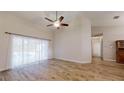 Bright living room with hardwood floors and sliding doors leading to the pool at 4475 Se 48Th Place Rd, Ocala, FL 34480