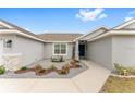 Inviting front entry with blue door and stone accents at 5050 Sw 91 Pl, Ocala, FL 34476