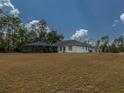 Single story home with a screened enclosure and a large yard at 726 Marion Oaks Ln, Ocala, FL 34473