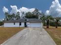 White house with attached garage and a long driveway at 726 Marion Oaks Ln, Ocala, FL 34473