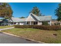 Delightful single-story home featuring a lush lawn, a driveway, attached garage, and a cozy covered porch at 8569 Sw 92Nd Ln # F, Ocala, FL 34481