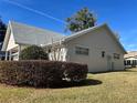 Tan house with gray roof and manicured hedges at 8569 Sw 92Nd Ln # F, Ocala, FL 34481