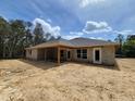 Back exterior showing the covered patio and block construction of the new home ready for finishing at 12295 Sw 90Th Pl, Dunnellon, FL 34432