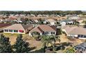 Aerial perspective of a house with backyard and neighborhood view at 13077 Se 86 Ct, Summerfield, FL 34491