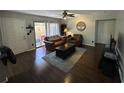 Living room with dark hardwood floors, leather furniture, and patio access at 1701 Se 24Th Rd # 201, Ocala, FL 34471
