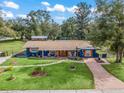 Newly renovated home with spacious yard, detached shed, and long driveway at 1905 Nw 25Th Ave, Ocala, FL 34475