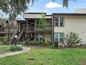 Front view of condo building with landscaping at 21202 Sandalwood Dr # 21-202, Wildwood, FL 34785