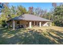 Brick ranch house with a large front porch and expansive lawn at 2821 Se 80Th St, Ocala, FL 34480