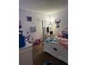 bedroom with Stitch-themed decor and white furniture at 52 Pine Trak # G 104, Ocala, FL 34472