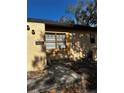 Tan stucco exterior with a walkway, bicycle, and tree at 52 Pine Trak # G 104, Ocala, FL 34472