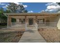 Inviting front porch with stone accents and a walkway leading to the main entrance at 6009 Sw 107Th St, Ocala, FL 34476