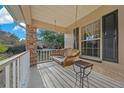 View of a porch swing on the covered front porch, perfect for relaxing outdoors at 6009 Sw 107Th St, Ocala, FL 34476