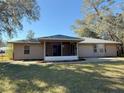 House with screened porch and flagstone patio at 73 Fir Dr, Ocala, FL 34472