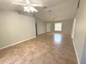 Spacious living room with tile floors and ceiling fans at 73 Fir Dr, Ocala, FL 34472