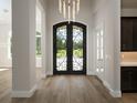 Grand entry with ornate double doors and hardwood floors at 7647 Nw 33Rd Pl, Ocala, FL 34482