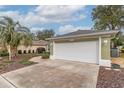 White garage door and driveway at 8310 Sw 79Th Cir, Ocala, FL 34481