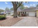 Attractive home exterior with a spacious front porch and a large tree in the foreground at 8723 Sw 93Rd Ln # C, Ocala, FL 34481