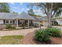 Charming single story home showcasing manicured landscaping, quaint front porch and attached two car garage at 8723 Sw 93Rd Ln # C, Ocala, FL 34481