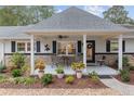 Relaxing front porch with rocking chairs, potted plants, and ceiling fan at 8723 Sw 93Rd Ln # C, Ocala, FL 34481
