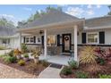 Peaceful front porch, perfect for relaxing, with rocking chairs and landscaping at 8723 Sw 93Rd Ln # C, Ocala, FL 34481