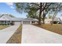 Home with a long driveway and landscaping at 8851 Sw 92Nd Pl # E, Ocala, FL 34481