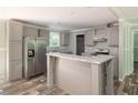 Modern kitchen with gray cabinets and island at 1143 Se 159Th Ct, Silver Springs, FL 34488