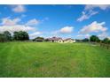 Wide shot of a home with a metal roof and sprawling green lawn under a sunny sky at 14130 Sw 8Th Ave, Ocala, FL 34473