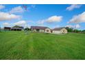 Home with a metal roof and large front yard, showcasing its picturesque setting at 14130 Sw 8Th Ave, Ocala, FL 34473