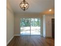 Bright dining room with sliding glass doors and hardwood floors at 14268 Se 27Th Ct, Summerfield, FL 34491