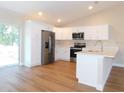 Modern kitchen featuring stainless steel appliances and white cabinets at 14268 Se 27Th Ct, Summerfield, FL 34491