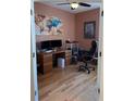 Home office with hardwood floors, dual monitors, and ample desk space at 16052 Sw 15Th Ct, Ocala, FL 34473