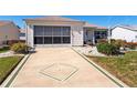 House with a decorative driveway and attached garage at 17370 Se 76Th Flintlock Ter, The Villages, FL 32162