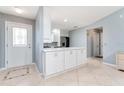 Modern kitchen with white cabinets, stainless steel appliances, and an island at 17370 Se 76Th Flintlock Ter, The Villages, FL 32162