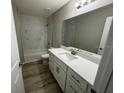 Modern bathroom with white cabinets, quartz countertop and bathtub at 1776 Sw 161St Pl, Ocala, FL 34473