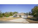 Single-story house with a two-car garage and fenced yard at 201 Emerald Loop Pass, Ocala, FL 34472