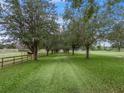 Long driveway lined with trees leading to a home at 20921 Sw 36Th St, Dunnellon, FL 34431